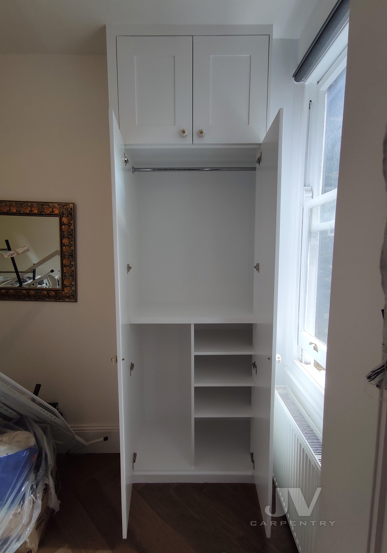 Wardrobe around window with doors open