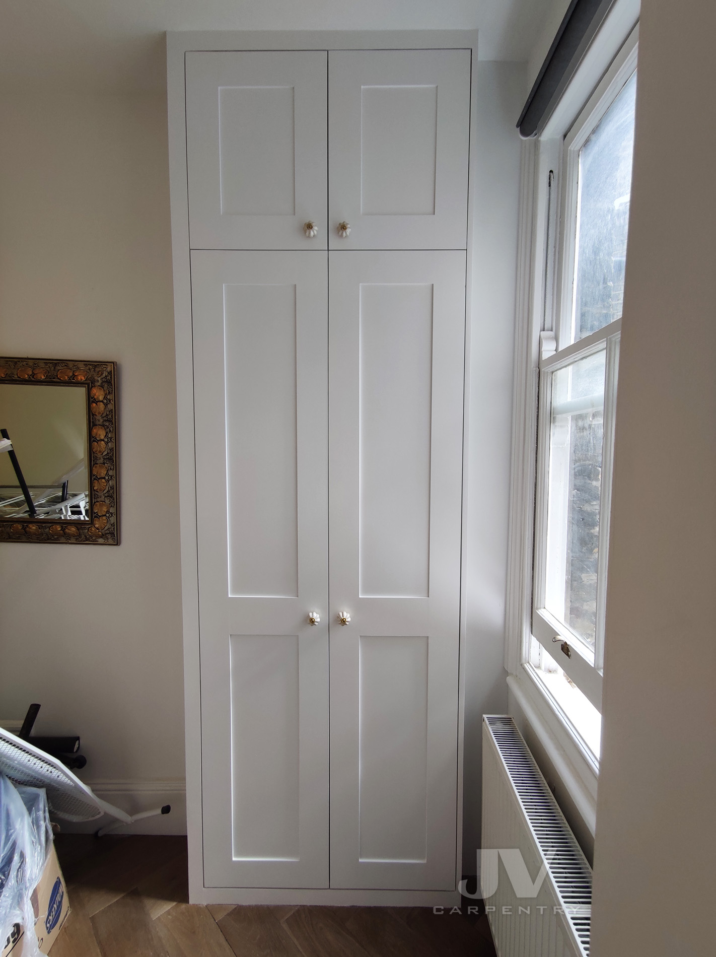 Built in wardrobe around window