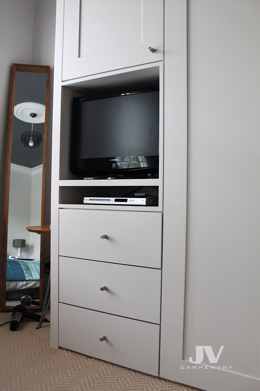 Fitted wardrobe with small TV