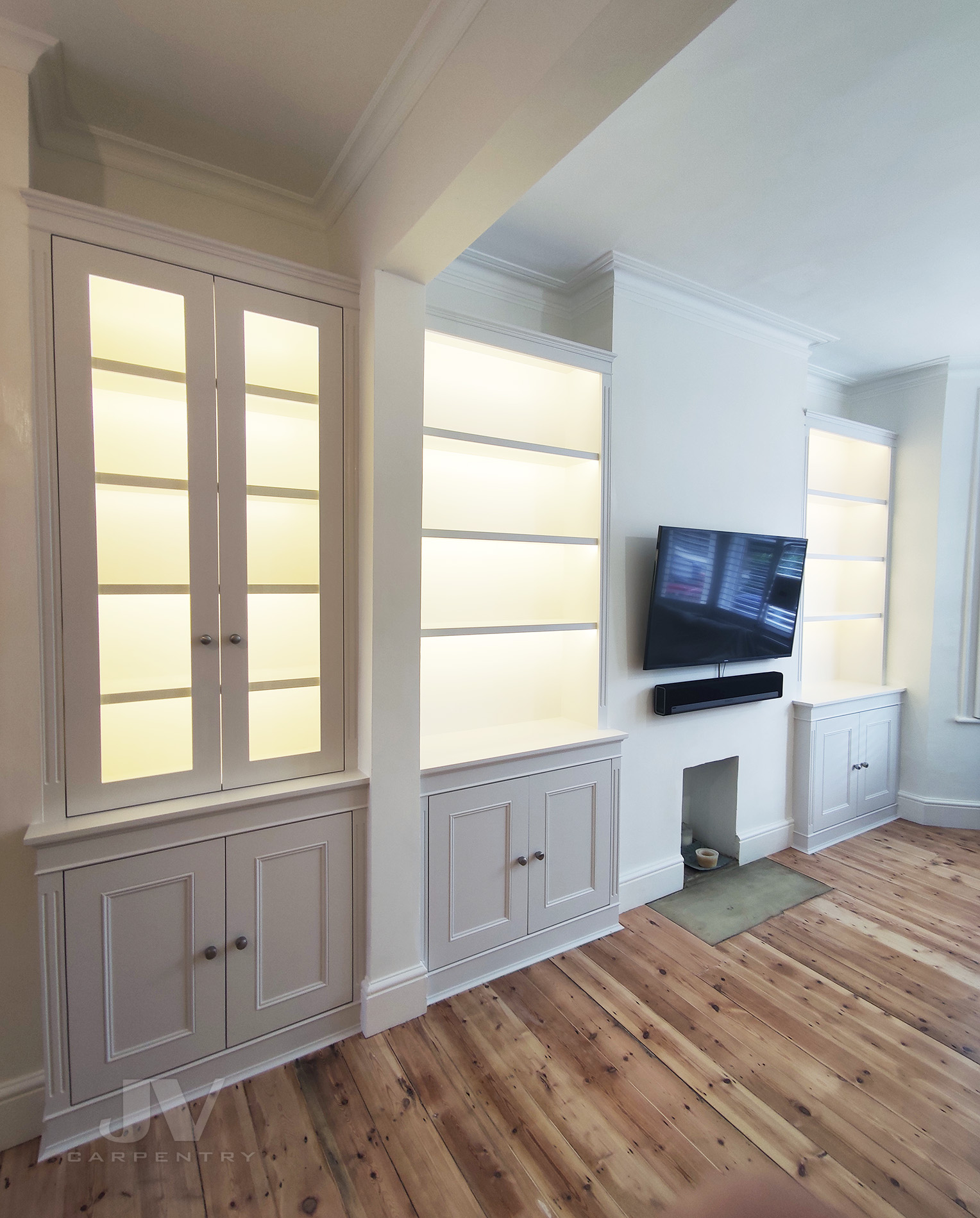 fitted alcove bookshelves with light