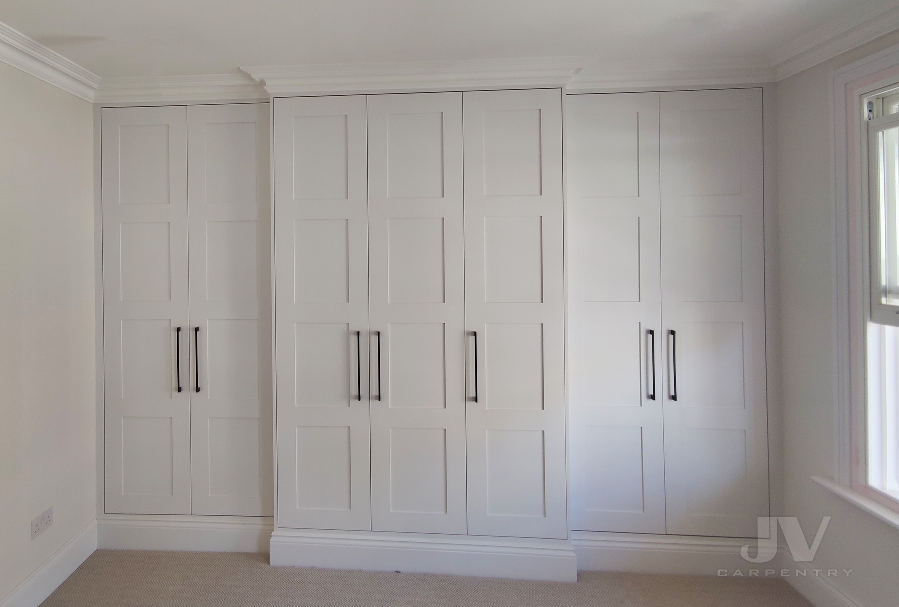 White wardrobe around chimney breast