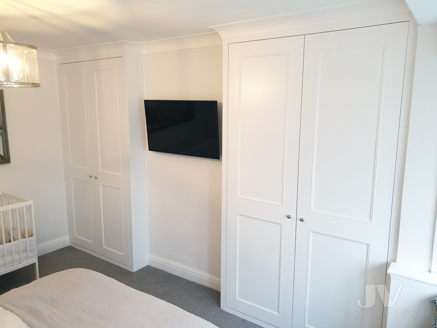 two white alcove wardrobes