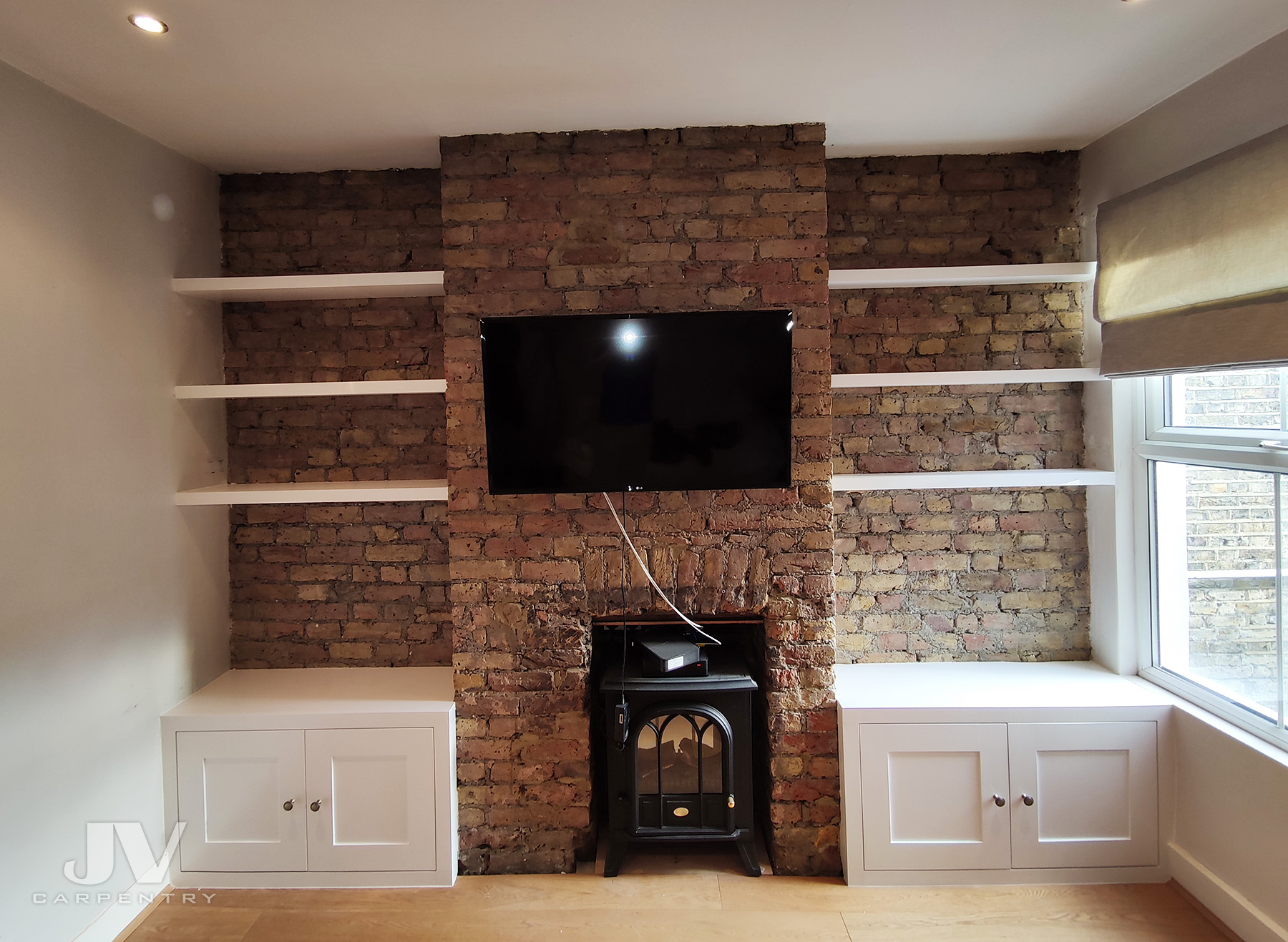 Shelving in exposed brick alcoves