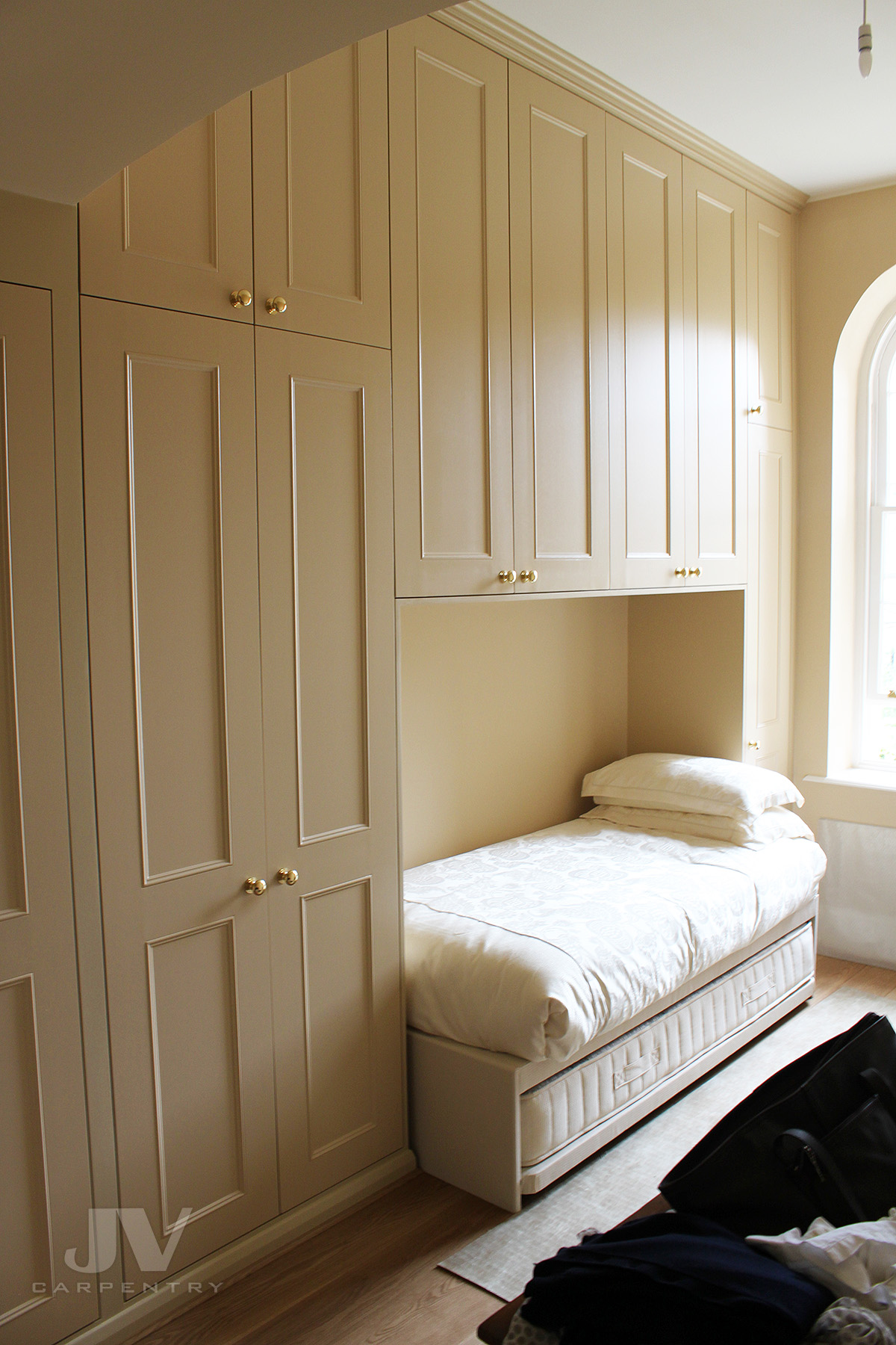 Fitted wardrobe around single bed