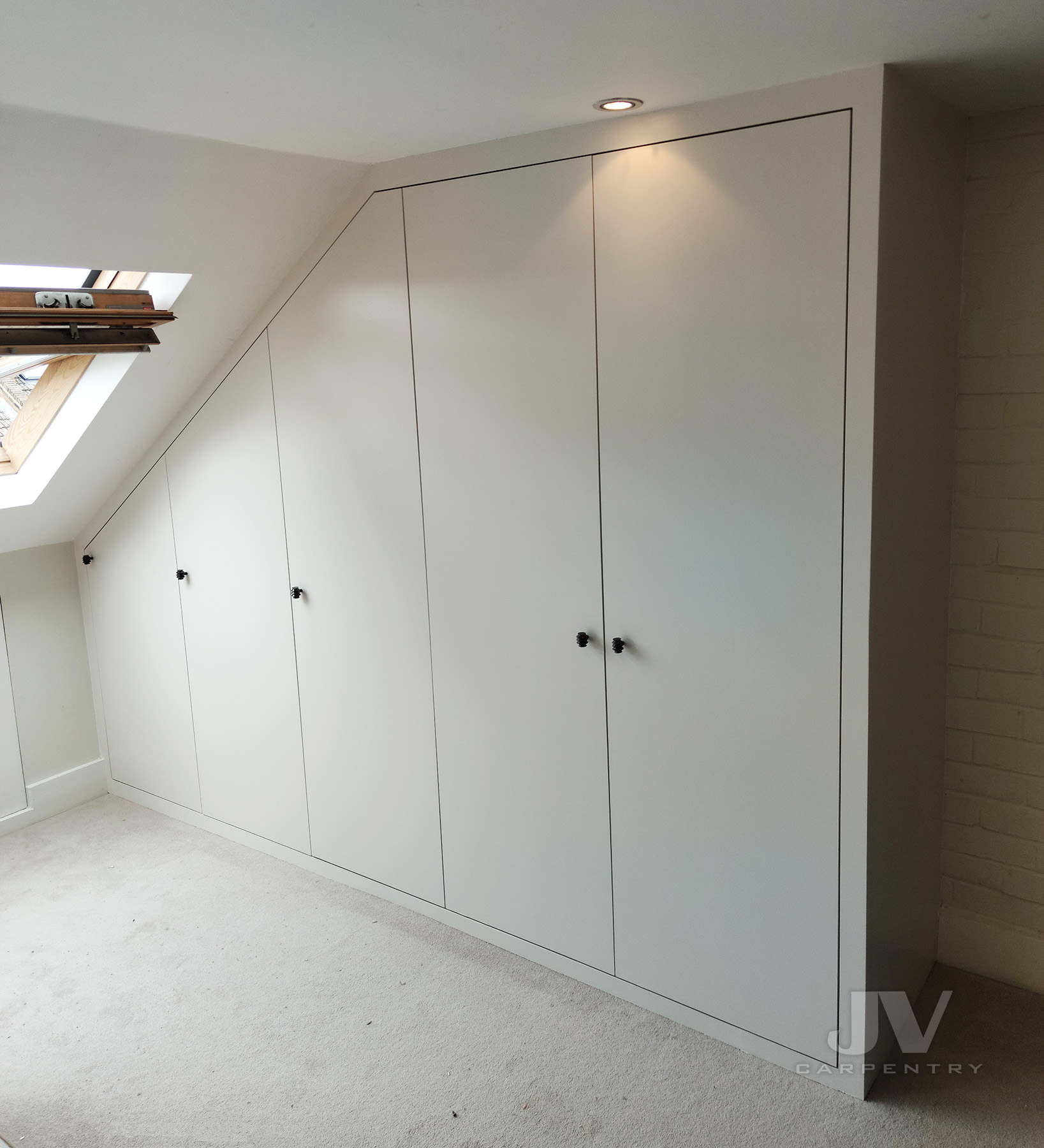 Attic wardrobe under sloping ceiling