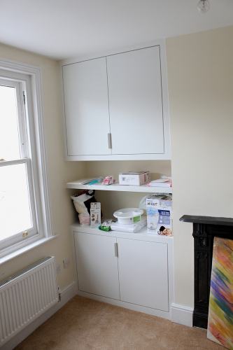 Alcove cabinets with overhead storage unit.