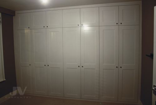 Built in wardrobe across hole bedroom wall