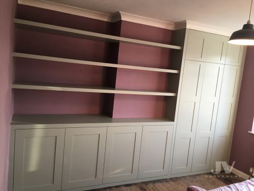 fitted alcove wardrobe with floating shelves and cabinets